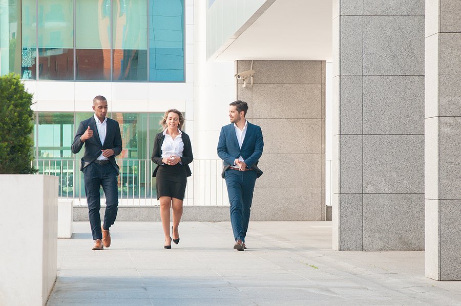Business colleagues walking outside office building